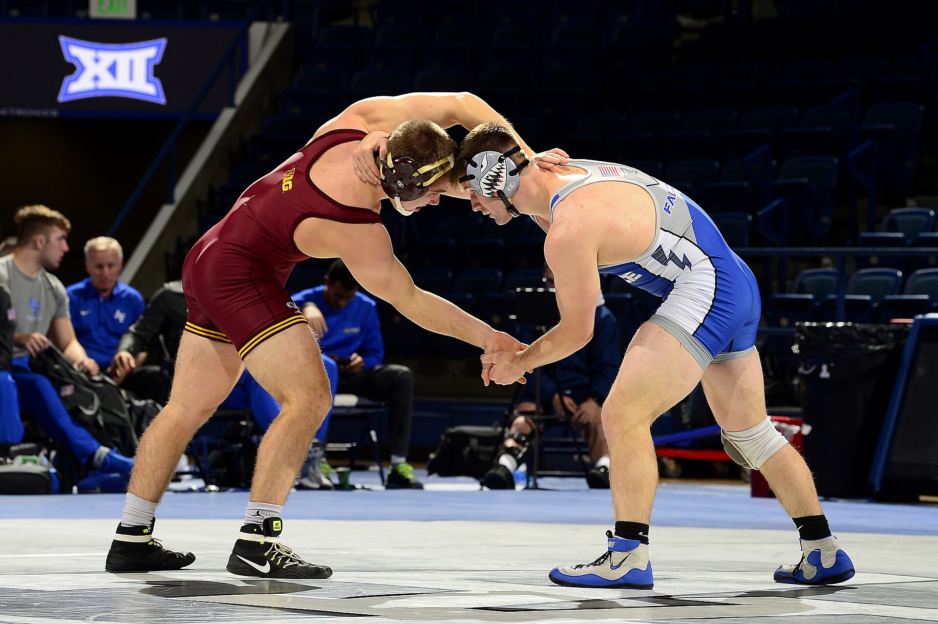 Two collegiate wrestlers in a tie-up